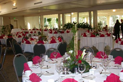 centerpieces at the reception of red roses gold bamboo dendrobium orchids