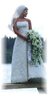 calla lilies, cassablanca lilies, dendrobium orchids, roses sweet peas, freesia, stephanotis make this dramatic cascade.