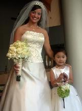 Flower girl holding hydrangias, stargazer lily, roses standing next to the bride holding her wedding bouquet made by her wedding coordinator.
