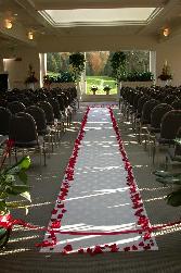 aisle framed by red rose petals to give the bride and her wedding party a beautiful walk.
