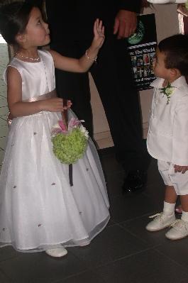 Flowergirl and ringbearer coordinated by the florist to match the others holding hydrangias, roses lilies made by their florist. 