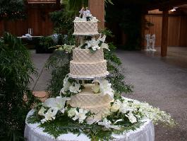  4 tiered cake with roses, orchids, lilies and gardenias