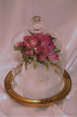 large glass dome with freeze dried rose wedding bouquet inside with the bridal veil