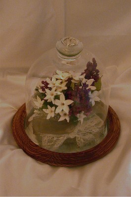 cake top displayed in a medium glass dome to display these gorgeous flowers