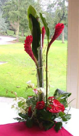 red ginger,red roses, red antherium, white freesia, white dendrobium orchids