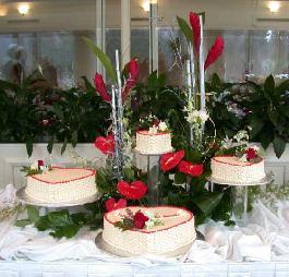 birthday cake surrounded by exotic flowers...ginger, antherium, orchids, roses, freesia and exotic greens.