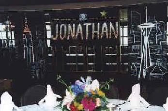 party planner coordinated the bar mitzvah with a scene from the skyline of New York and Seattle. flowers include iris, stargazers, roses, statis and wax flowers.