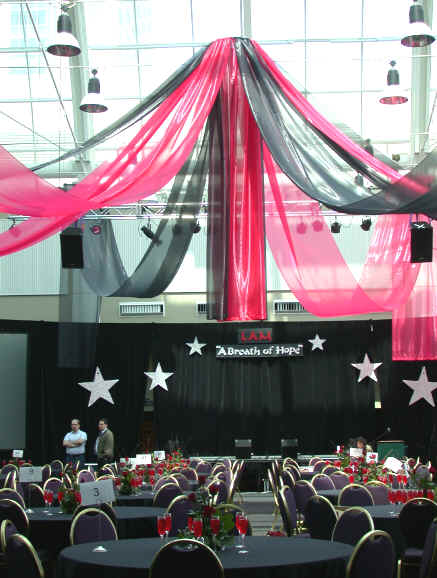 Huge convention room filled with one hundred centerpieces all expertly designed by our party planners.
