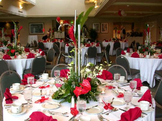 a room full of exotic flowers from hawaii, antherium, roses, ginger, dendrobium orchids, freesia, silver bamboo and exotic greenery 